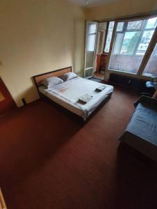 a bedroom with a bed and a large window at Business Park Budget Stay in Sofia