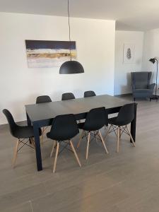 een eettafel met zwarte stoelen en veel licht bij Hacienda Donaire Beas in Beas