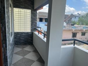 a balcony with a view of a building at Rt Service Apartments Hotel in Velankanni