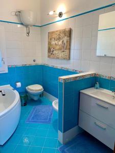 雷亞爾蒙泰的住宿－La Terrazza di Nonna Maria，蓝色和白色的浴室设有卫生间和水槽
