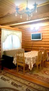 布克維的住宿－Cottage Kalinka，一间带桌椅和电视的用餐室