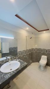 a bathroom with a sink and a toilet at Amyl's Garden in Islamabad