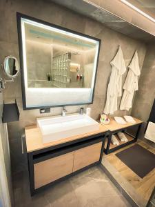 a bathroom with a sink and a large mirror at Design Loft Herford in Herford