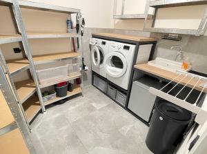 a laundry room with a washer and dryer at Design Loft Herford in Herford