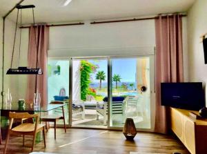 a living room with a glass table and a patio at My Space on the Beach, Luxury Apartment in Casares