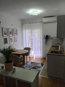 a kitchen and dining room with a table and a sink at Studio SIESTA in Vrnjačka Banja