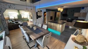 a dining room and kitchen with a table and chairs at Maison Gite Chez Nounou sauna jacuzzi jardin arboré non clôturé in Etting