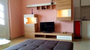 a living room with a tv on a wooden entertainment center at SARITA Apartments 1 in Makarska