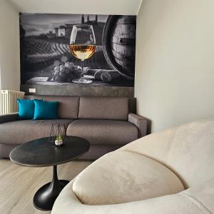a living room with a couch and a glass of wine at Casa Belvì - Family Appartement Lugana-Sirmione in San Martino della Battaglia