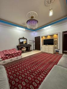a bedroom with a bed and a large red rug at شقة بغرفتين ودورتين في الدور الأول 7 دقائق للحرم in Al Madinah +10 photos