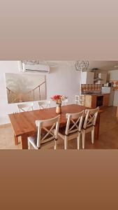 a dining room with a wooden table and chairs at Apartamento Daniella Nerja in Nerja