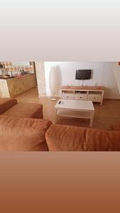 a living room with a couch and a table at Apartamento Daniella Nerja in Nerja