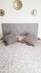 a bed with two pillows on top of it at Apartamento Daniella Nerja in Nerja