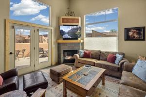 a living room with a couch and a fireplace at Rim Village I1 in Moab