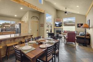 a dining room and living room with a table and chairs at Rim Village I1 in Moab