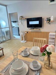 tavolo da pranzo con piatti e fiori di 1 Bed 1 Bath Apartment a Kathu