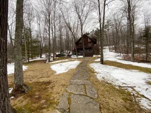 a path leading to a log cabin in the woods at Grand View Log Cabin in Seeley