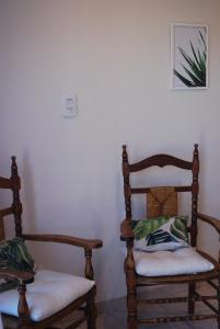 two wooden chairs in a room with white walls at VASALISA in Tres Arroyos