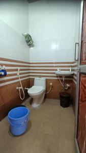 a bathroom with a toilet and a sink at Keshav Narayan Home Stay in Mathura +7 photos