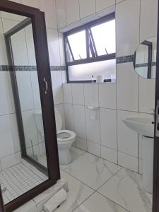 a bathroom with a toilet and a sink at Onamungundo Backpackers in Walvis Bay
