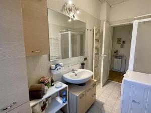 a bathroom with a sink and a mirror at Sweet Apartment for Friends and Family in Valpolicella in San Pietro in Cariano +18 photos
