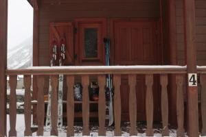 Die Veranda einer Hütte mit Skiern und Schnee in der Unterkunft Camping Boneta in Barruera