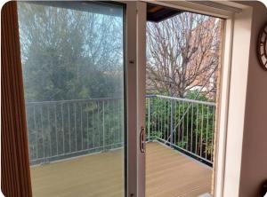 a sliding glass door with a view of a balcony at A stunning room in a 2 bed apartments in the heart of Medway in Gillingham