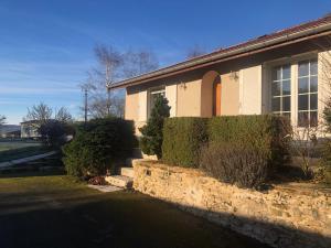 a house with a stone wall in front of it at Gite de l'Ancheronne 12 couchages spa in Lavans-sur-Valouse