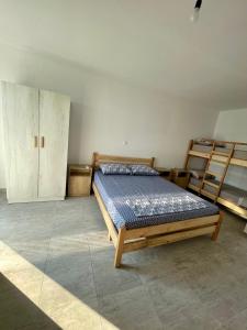 a bedroom with a bed and two bunk beds at Villa Kate in Borsh
