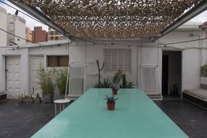 a green table on the roof of a building at Aldea Hostel in Córdoba