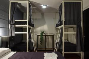 a bedroom with two bunk beds and a mirror at Aldea Hostel in Córdoba