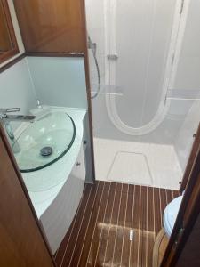 a bathroom with a glass sink and a shower at Gestione Mare Diving & Charter in Siracusa