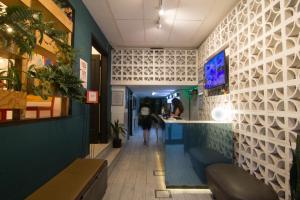 a corridor of a restaurant with a counter and a bar at Aldea Hostel & Café in Cordoba