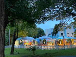 a group of domes are lined up in a field at Atlantis Villa Best homestay malaka in Kampong Alor Gajah