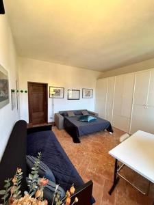 a bedroom with a bed and a couch at Elegant apartment inside Villa Fontana in Tremezzo