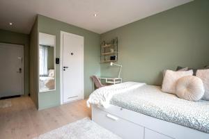 a bedroom with a bed and a room with a mirror at Newly renovated studio apartment at Frogner in Oslo
