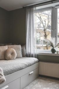 a bed in a room with a window at Newly renovated studio apartment at Frogner in Oslo