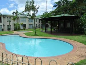 a large swimming pool with a gazebo in front of a building at The Bridge 38 in St Lucia