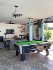 a living room with a pool table in a room at Atlantis Villa Best homestay malaka in Kampong Alor Gajah