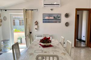 una sala da pranzo con tavolo e fiori di Luxury Home Cabras Centro a Càbras