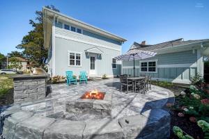a patio with a fire pit in front of a house at Lux Beach Home Lake Views Firepit in South Haven