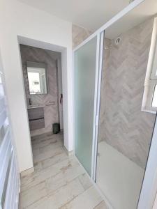 a bathroom with a walk in shower and a sink at Le Cabanon, pieds dans l'eau, vue exceptionnelle in Fréjus +19 photos