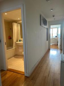 a hallway with a bathroom with a tub and a toilet at The Fitz Apartment in Dublin