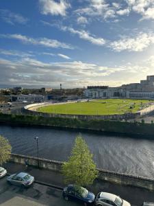 a parking lot with cars parked next to a river at The Fitz Apartment in Dublin