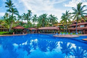 a swimming pool at a resort with palm trees at Los Tules Ocean Front Suite 902 - 3rd floor in Puerto Vallarta
