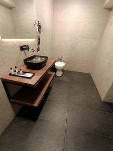 a bathroom with a sink and a toilet at Hotel El Salvador in Mexico City