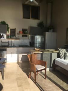 a kitchen with a table and chairs and a couch at Los Tules King Suite in Puerto Vallarta