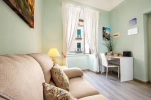 a living room with a couch and a table and a window at Casa Rosaria in Atrani