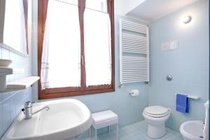 a bathroom with a white sink and a toilet at Giudecca in Venice