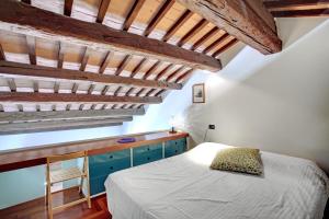 a bedroom with a bed and blue cabinets and wooden ceilings at Giudecca in Venice